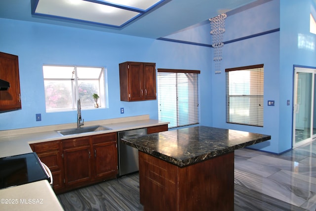 kitchen featuring a center island, stove, exhaust hood, sink, and stainless steel dishwasher