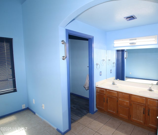 bathroom featuring tile patterned flooring and vanity