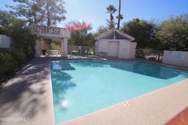 community pool featuring a patio area and fence