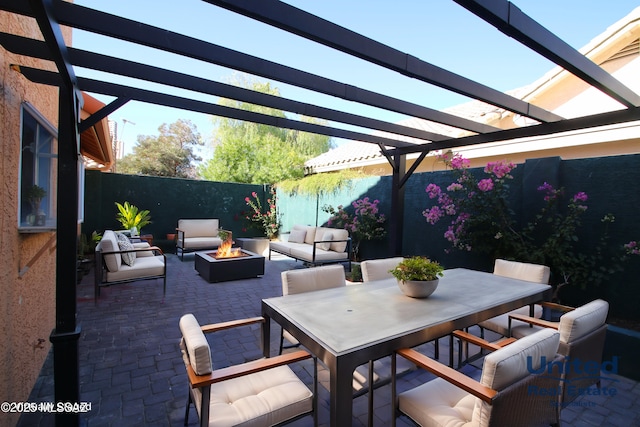 view of patio featuring a pergola and an outdoor living space with a fire pit