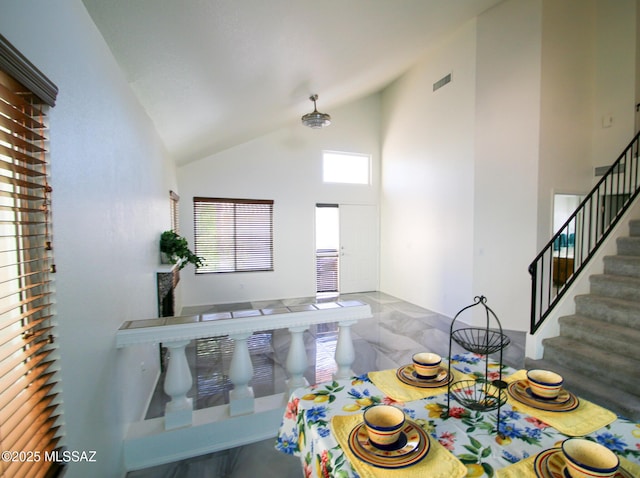 playroom with high vaulted ceiling, marble finish floor, and visible vents