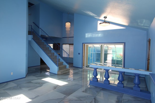 interior space featuring high vaulted ceiling and a textured ceiling