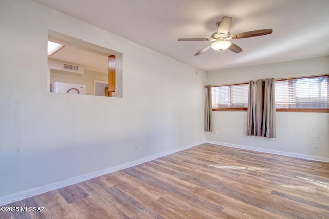 spare room with hardwood / wood-style floors and ceiling fan