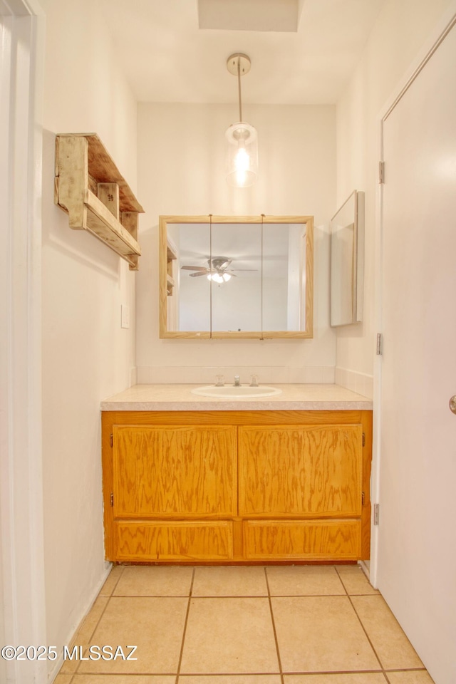 bathroom with tile patterned flooring, ceiling fan, and vanity