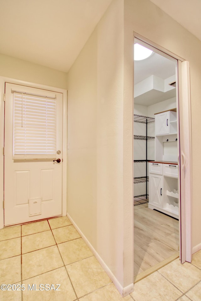 hallway with light tile patterned floors