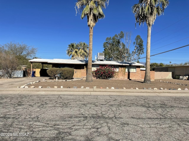 view of front of property featuring a carport