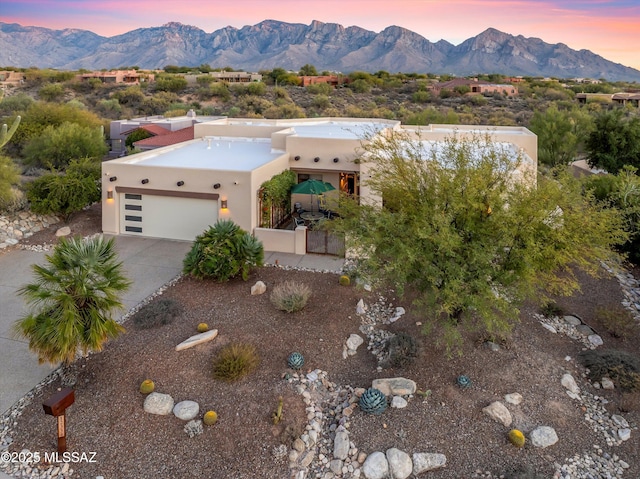 view of front of home featuring a garage and a mountain view