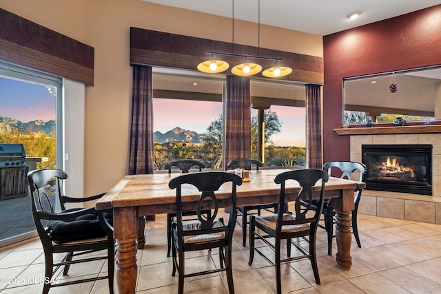 tiled dining area with a tiled fireplace