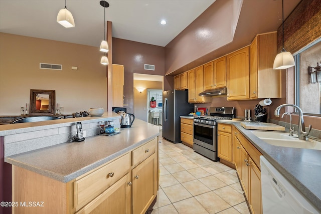 kitchen with hanging light fixtures, sink, stainless steel appliances, light tile patterned floors, and light brown cabinets