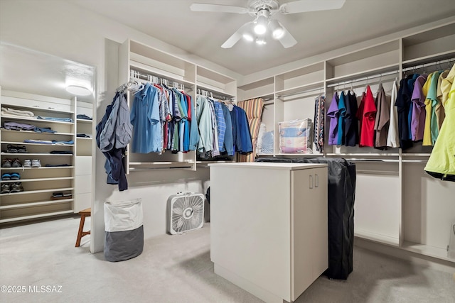 walk in closet with carpet flooring and ceiling fan