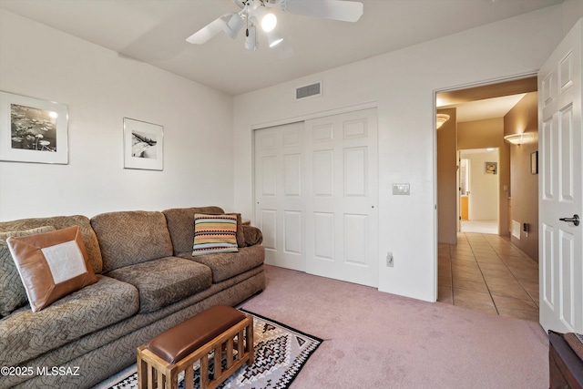 living room with ceiling fan and light tile patterned floors