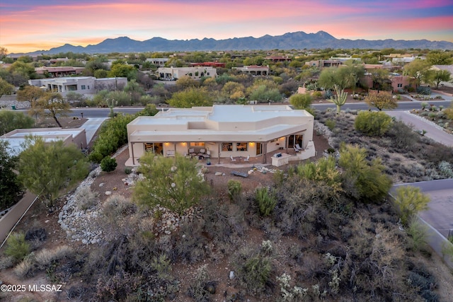 aerial view at dusk featuring a mountain view