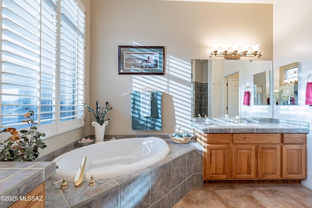 bathroom featuring vanity and tiled tub