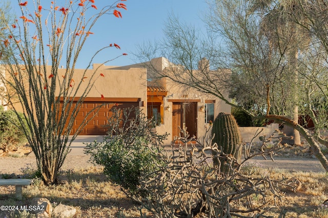 pueblo-style house with a garage