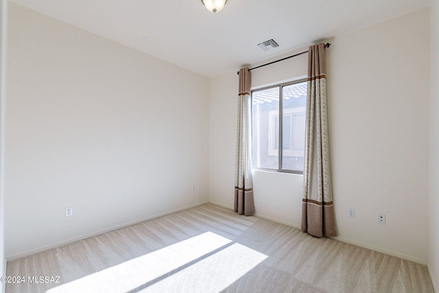 empty room with light colored carpet