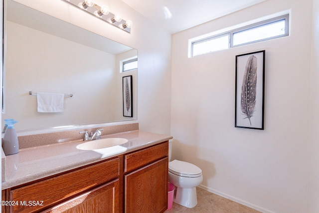 bathroom with tile patterned flooring, vanity, and toilet