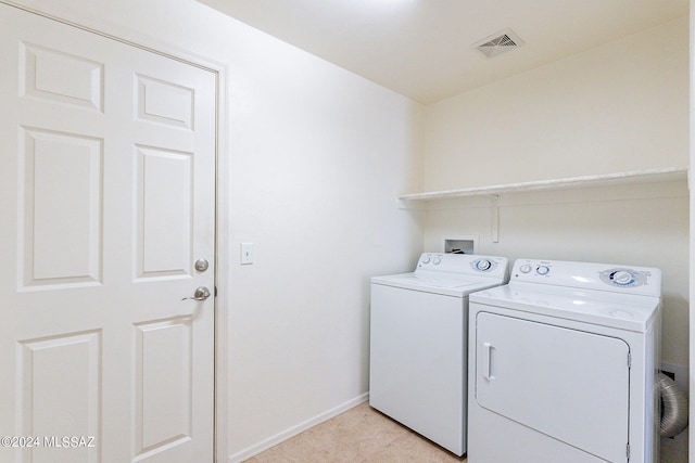 laundry room featuring washer and clothes dryer and light tile patterned flooring