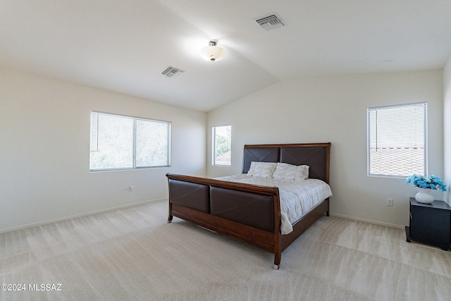 carpeted bedroom with vaulted ceiling