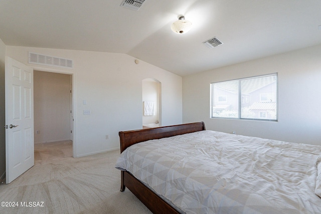 carpeted bedroom with lofted ceiling