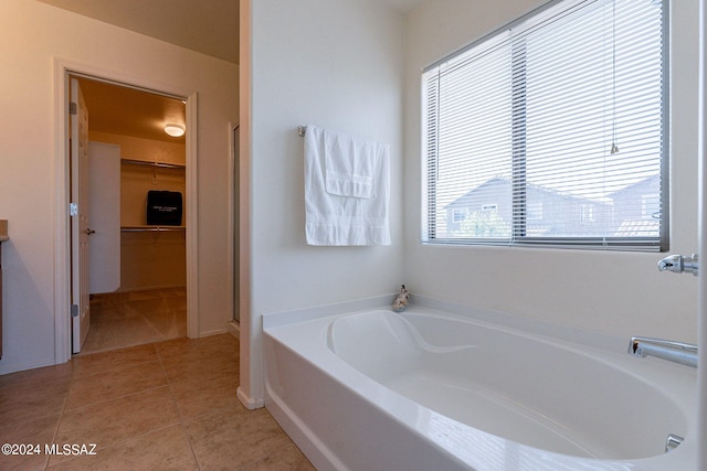 bathroom with vanity, tile patterned floors, and a bathing tub