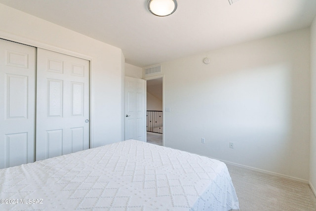 carpeted bedroom featuring a closet