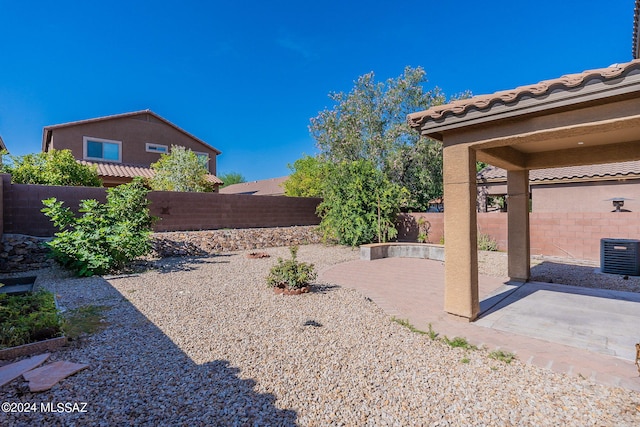 view of yard featuring a patio area and central AC