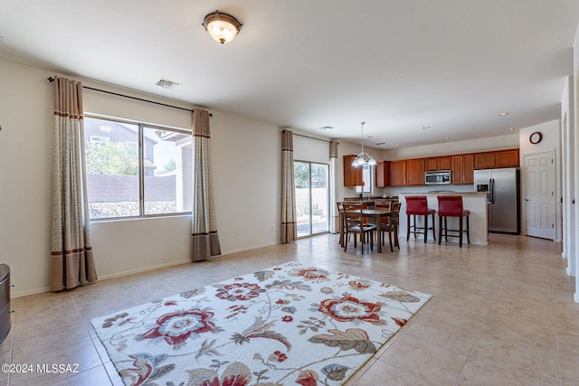 interior space featuring light tile patterned floors and an inviting chandelier