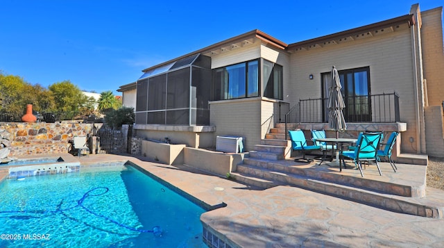 view of pool with a patio area and a sunroom