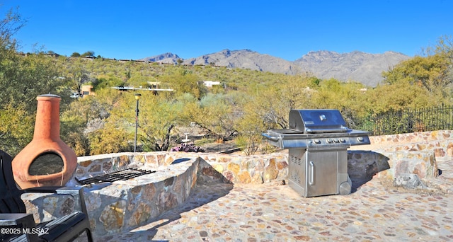 view of patio featuring a mountain view and grilling area