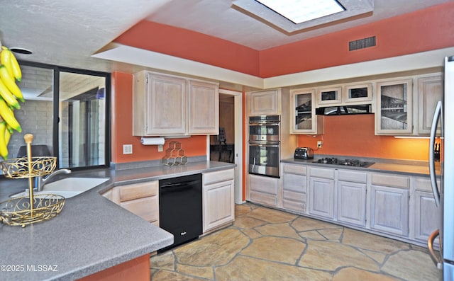 kitchen featuring light brown cabinetry, sink, and stainless steel appliances