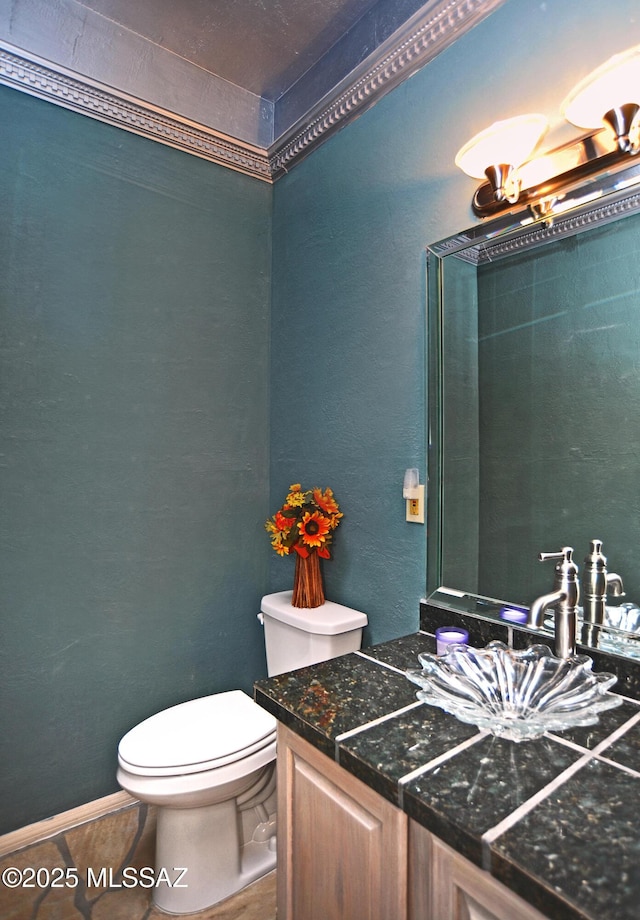 bathroom with tile patterned flooring, vanity, and toilet