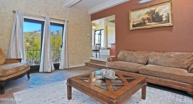 living room with beam ceiling and plenty of natural light