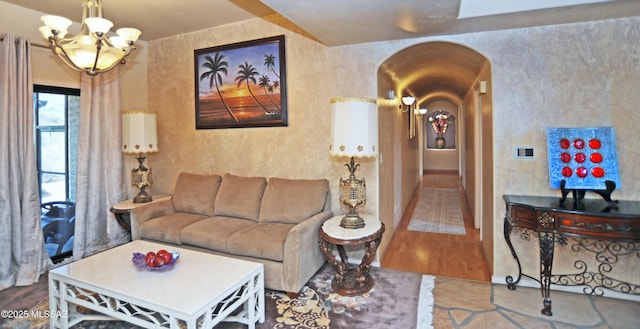 living room with a chandelier and wood-type flooring