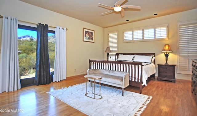 bedroom featuring light hardwood / wood-style floors, multiple windows, and ceiling fan