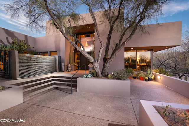 view of patio terrace at dusk