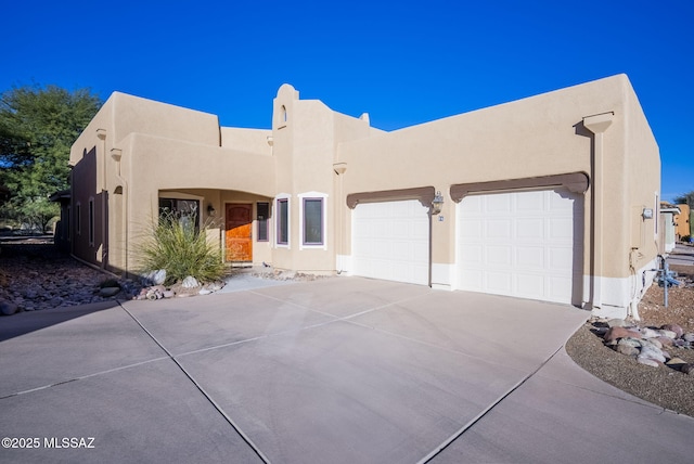 pueblo-style house with a garage