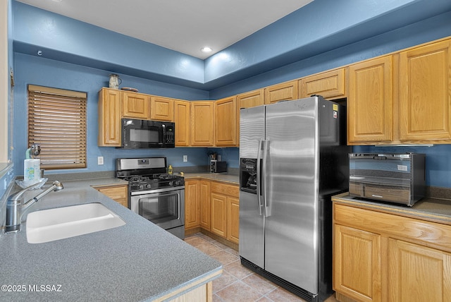 kitchen featuring light tile patterned floors, stainless steel appliances, and sink