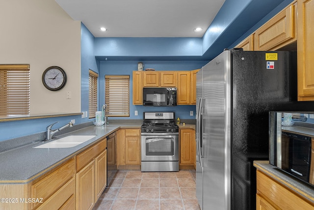 kitchen featuring sink, light tile patterned floors, black appliances, and light brown cabinets