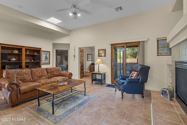 living room with ceiling fan and light tile patterned flooring