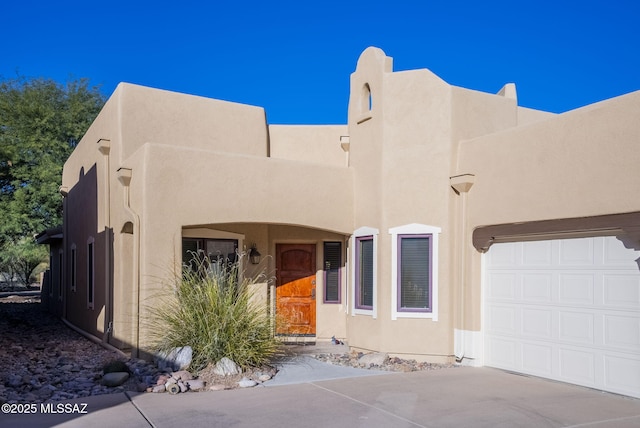 southwest-style home featuring a garage