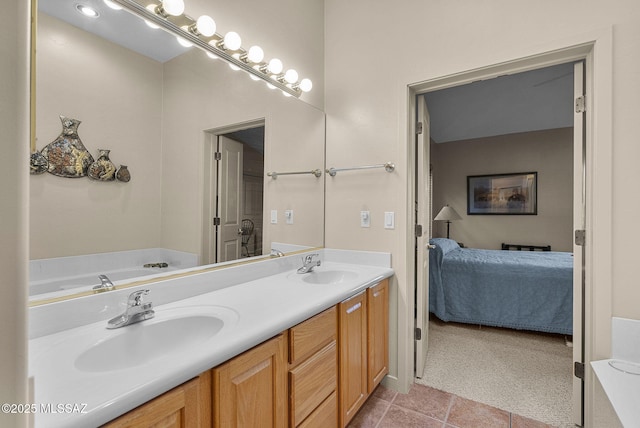 bathroom featuring tile patterned flooring, vanity, and a bathing tub