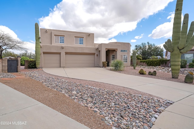 pueblo-style home with a garage