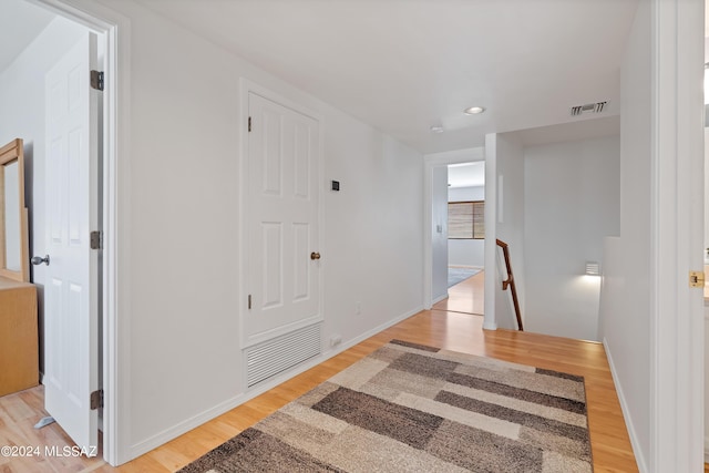 corridor with light hardwood / wood-style flooring