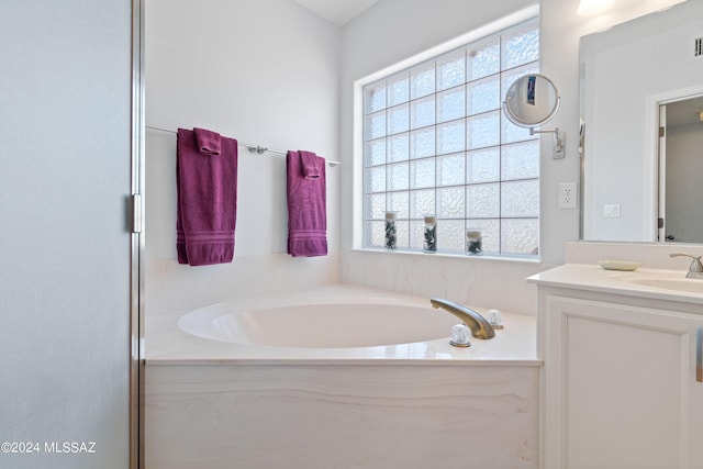 bathroom featuring a washtub and vanity