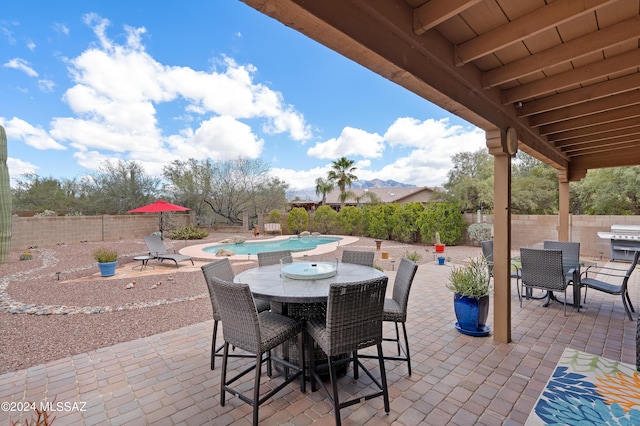 view of patio featuring a fenced in pool