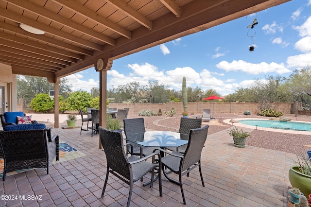 view of patio with a fenced in pool