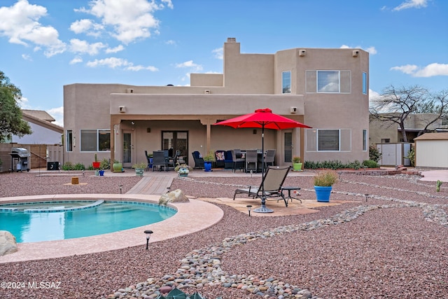 view of pool featuring an in ground hot tub, a patio, and grilling area