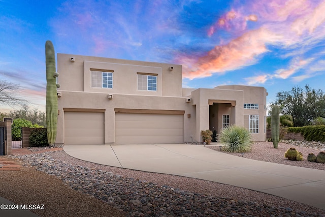 pueblo-style home with a garage