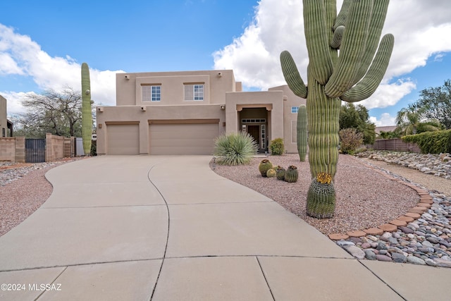 pueblo-style home with a garage