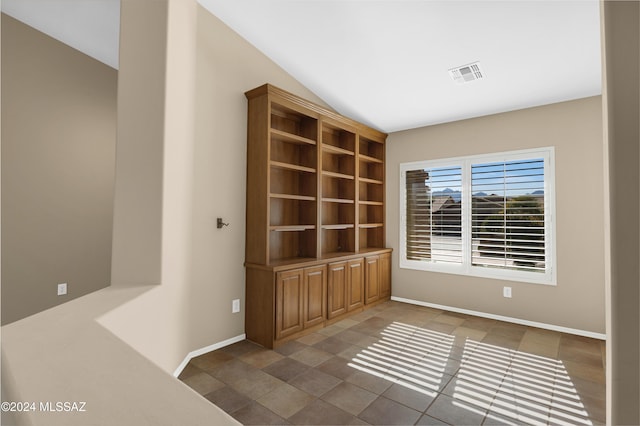 unfurnished room with lofted ceiling